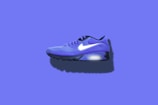 blue, white, and black Nike running shoes