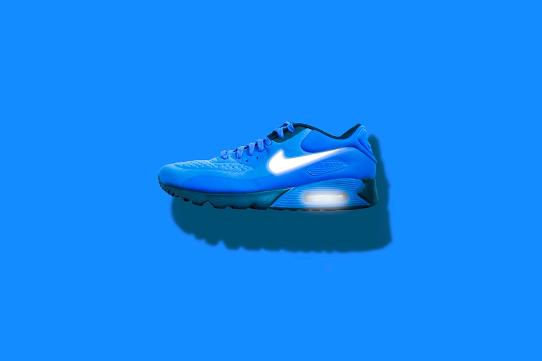 blue, white, and black Nike running shoes