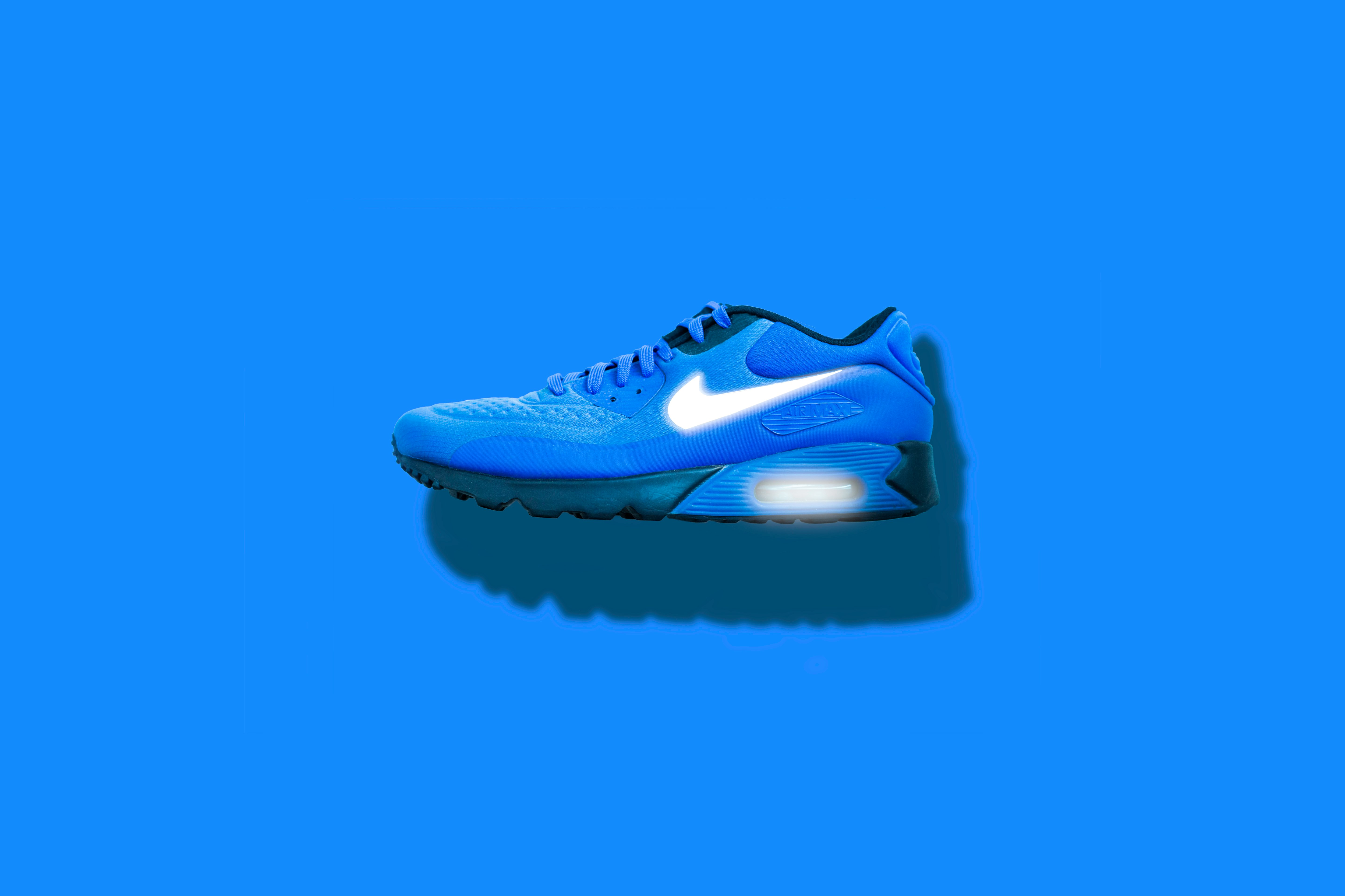blue, white, and black Nike running shoes