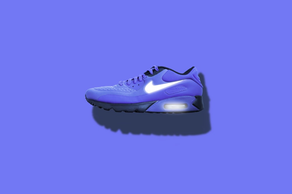 blue, white, and black Nike running shoes