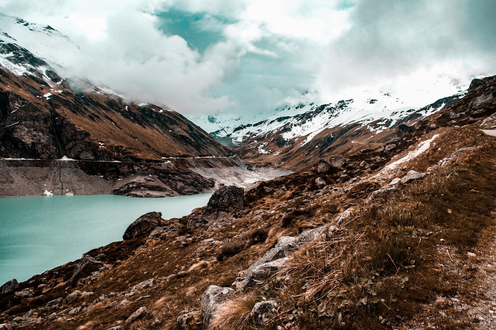 body of water surrounded with mountain