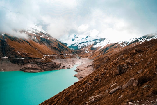 river between brown mountains landscape photography during daytime in Lac de Moiry Switzerland