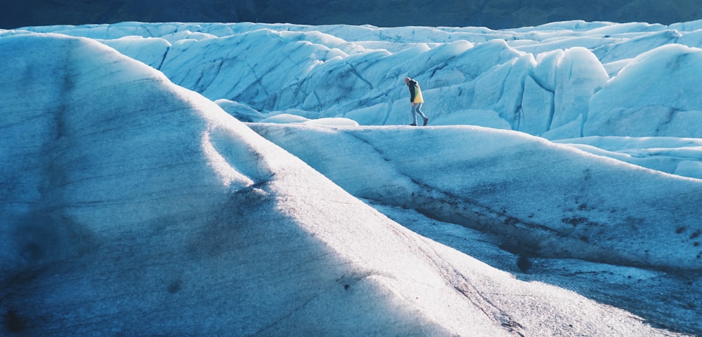 man walking on snow mountain