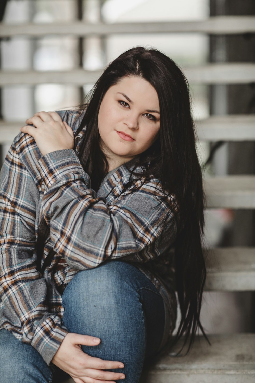 woman wearing brown and black plaid dress shirt smiling white taking picture