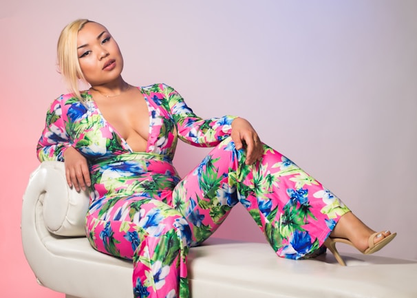 A model lounging comfortably on a plush sofa wearing a pastel-colored loungewear set.