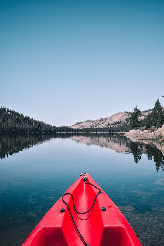 person capturing forest and mountain while in kayak in Lake Mary United States