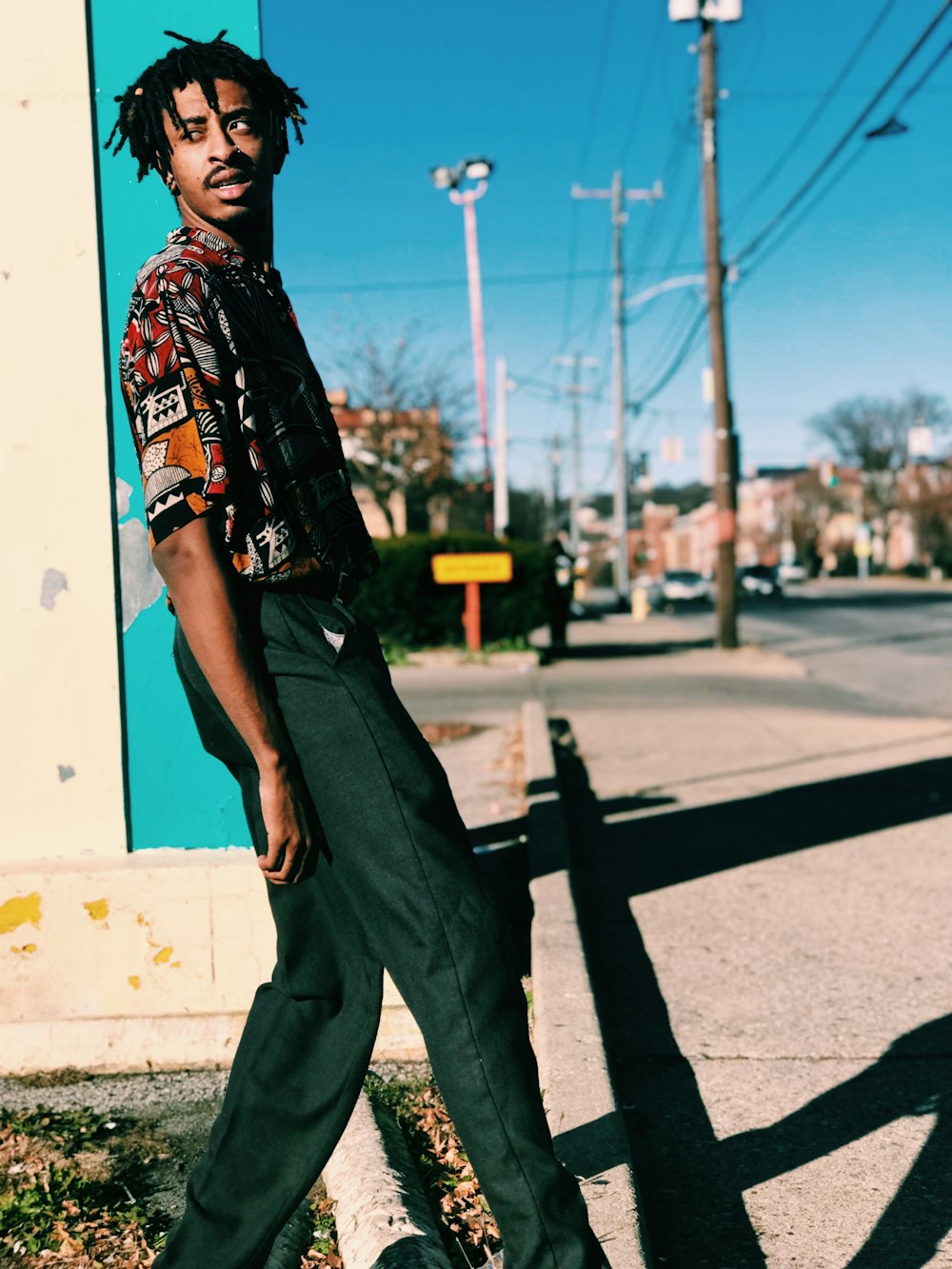 man walking outdoor looking back during daytime