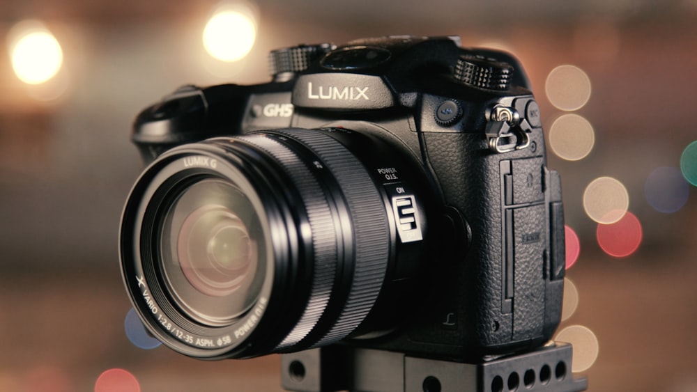 bokeh photography of black Lumix DSLR camera