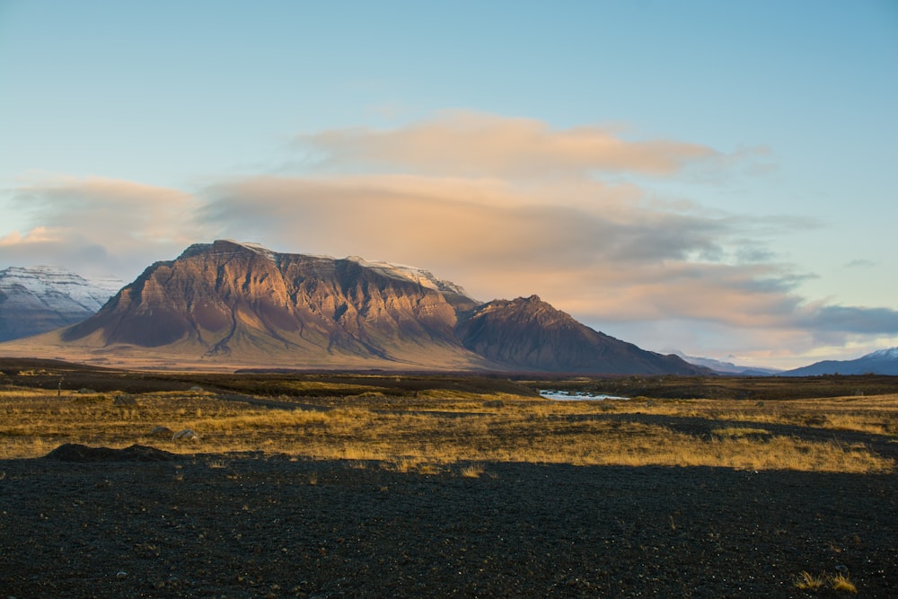 mountain under white clouds at daytime