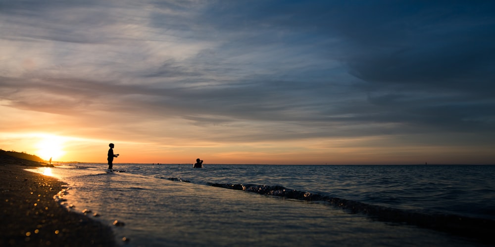 person in sea during sunset