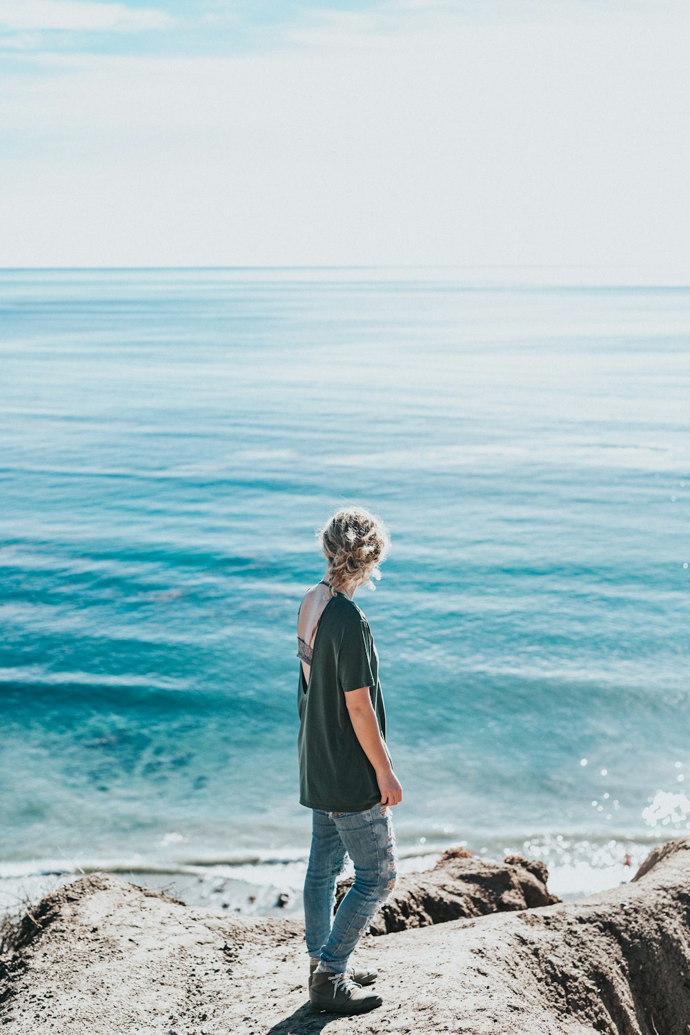 woman standing next to sea