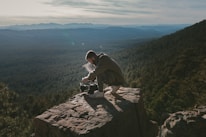 An influencer capturing breathtaking landscapes with a camera during an outdoor expedition.