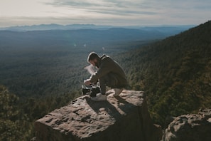 Cinematographer capturing a breathtaking landscape during filming.