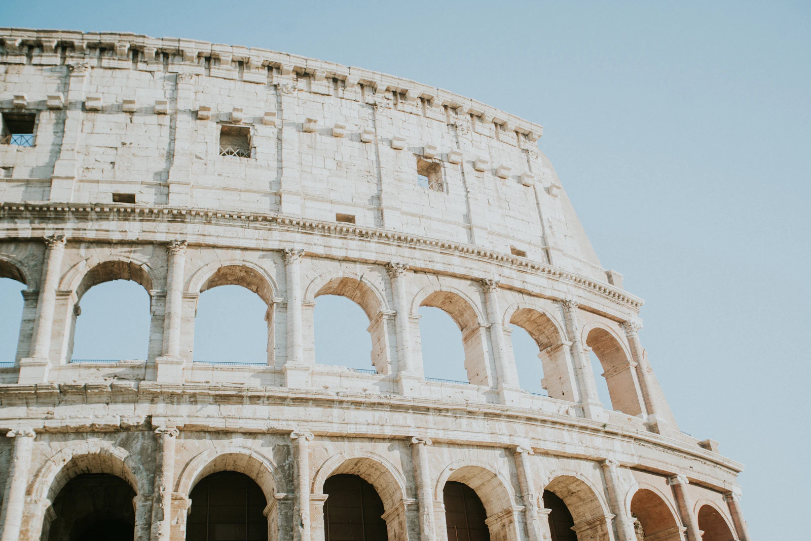 The Colosseum in Rome under a clear sky