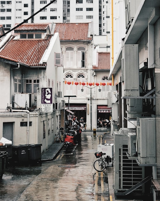 white air condenser mounted on white concrete building in Chinatown Singapore Singapore