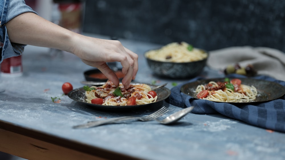 person holding spaghetti