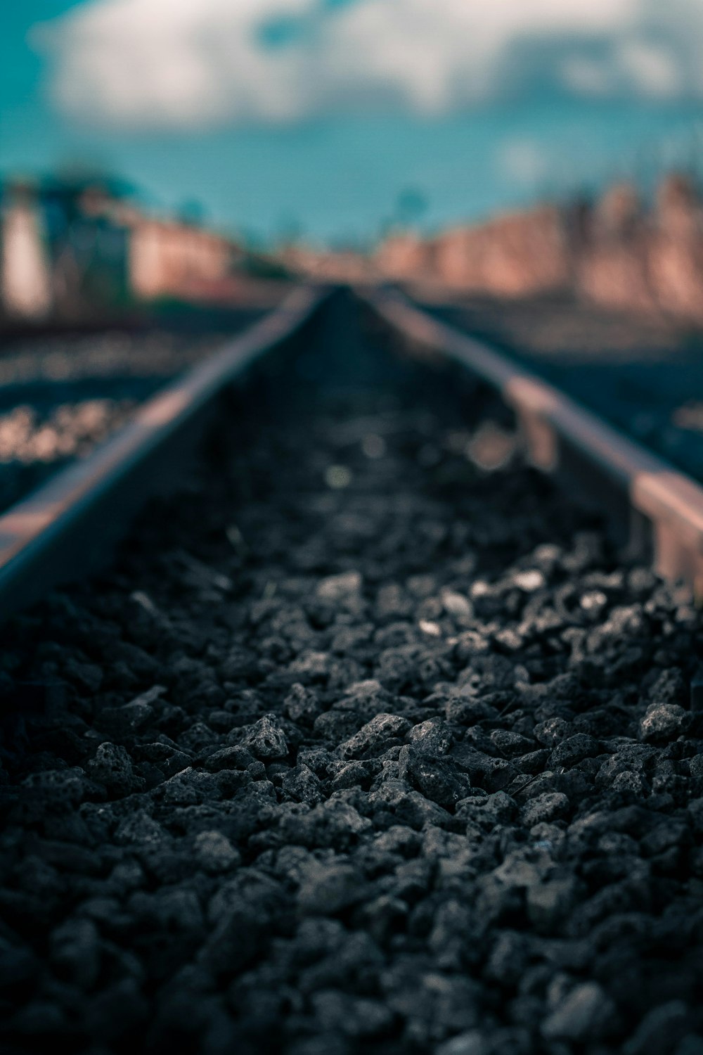 selective focus photography of stone on railroad