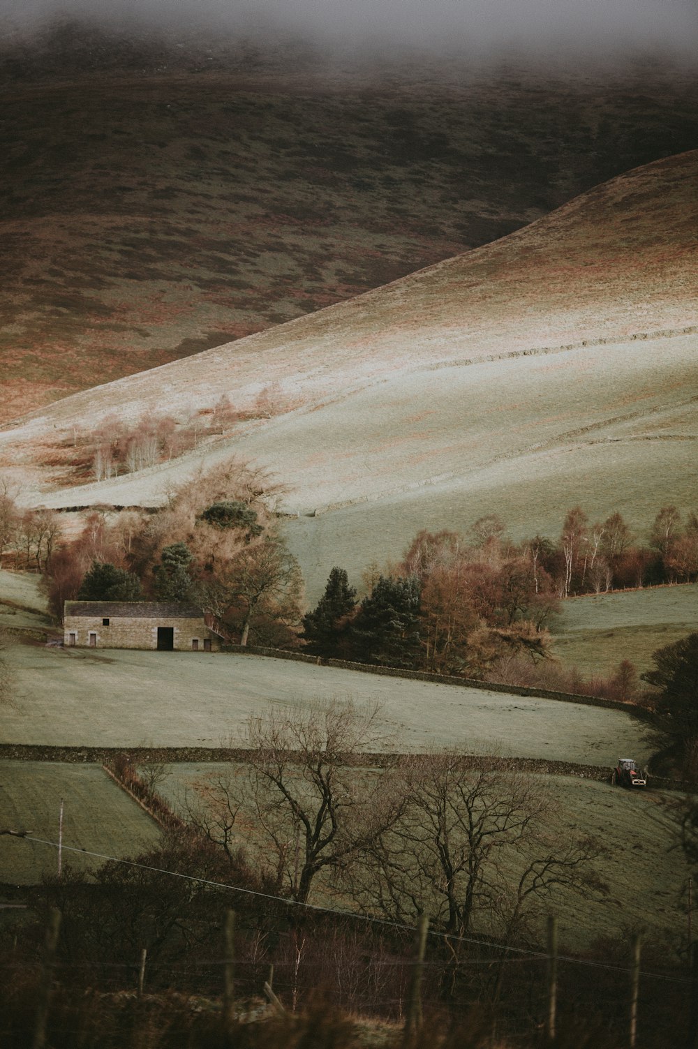 farmland with brown building during daytime