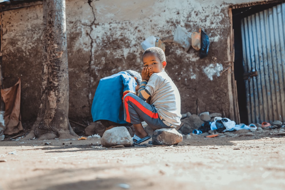 boy sitting on rock