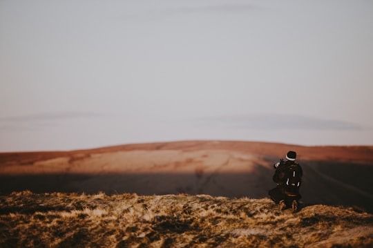 person standing on open field in Mam Tor United Kingdom