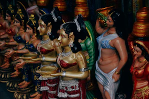 A group shot of various figurines from different hermandades, showcasing the diversity of styles and colors.