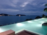 A serene view of an infinity pool at dusk.