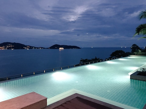 A serene view of an infinity pool at dusk.