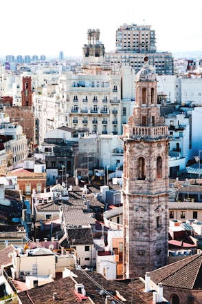 aerial photography of beige tower surrounded by houses during daytime