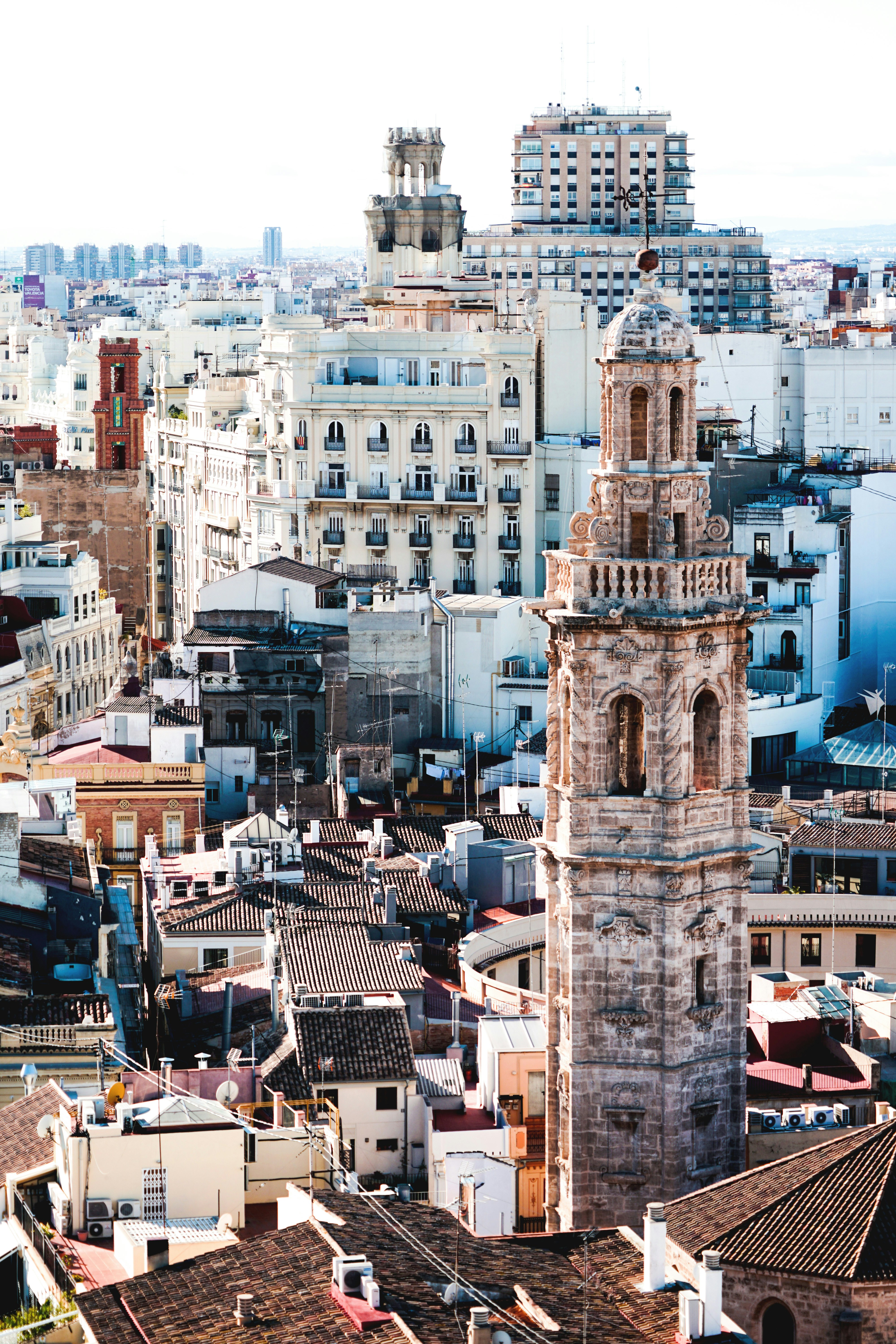 aerial photography of beige tower surrounded by houses during daytime