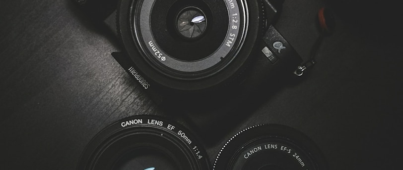 flat lay photography of black Sony DSLR camera on black surface