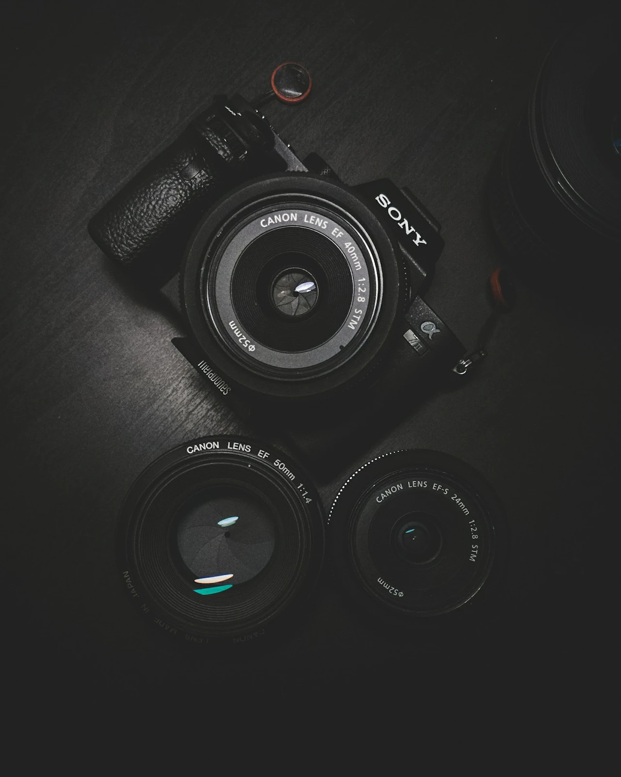 A layout of photography gear: camera, lens, tripod and filters