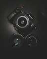 flat lay photography of black Sony DSLR camera on black surface