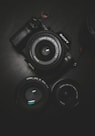 flat lay photography of black Sony DSLR camera on black surface