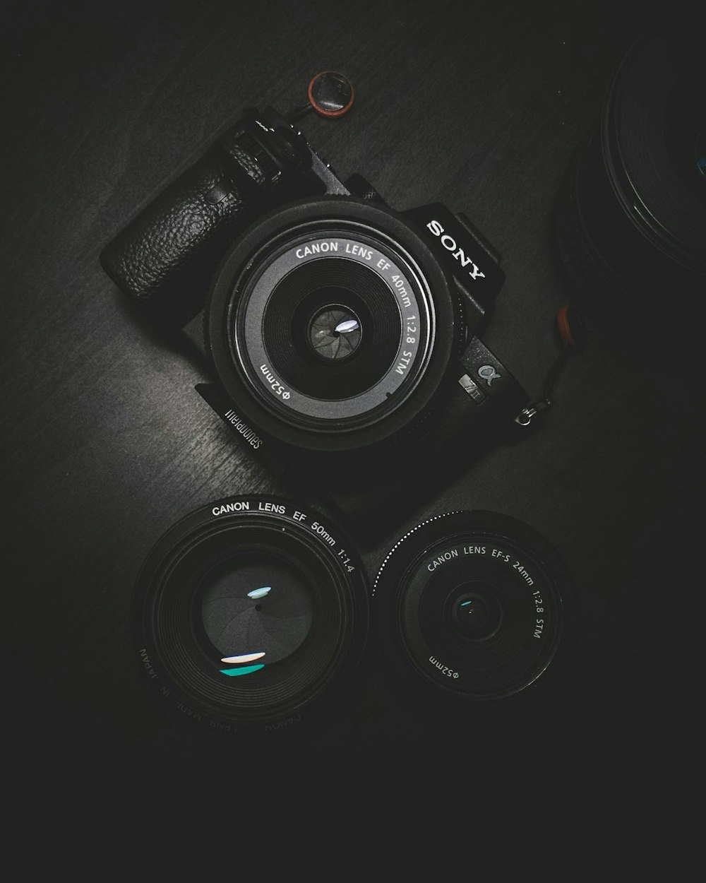 flat lay photography of black Sony DSLR camera on black surface