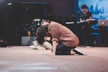 An intimate moment of a Christian music artist praying before a performance.