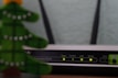 Home broadband router with glowing signal lights in a cozy living room
