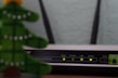 Close-up of a modern modem router with indicator lights lit up.