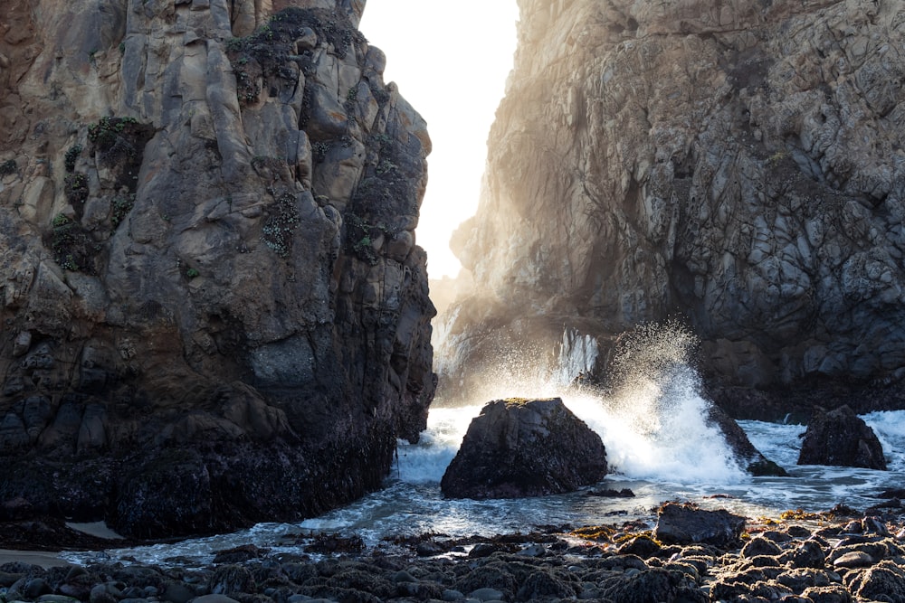 time lapse photography of body of water between cliffs