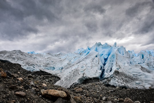 mountain covered with ice under grey cloudy sky in Perito Moreno Glacier Argentina