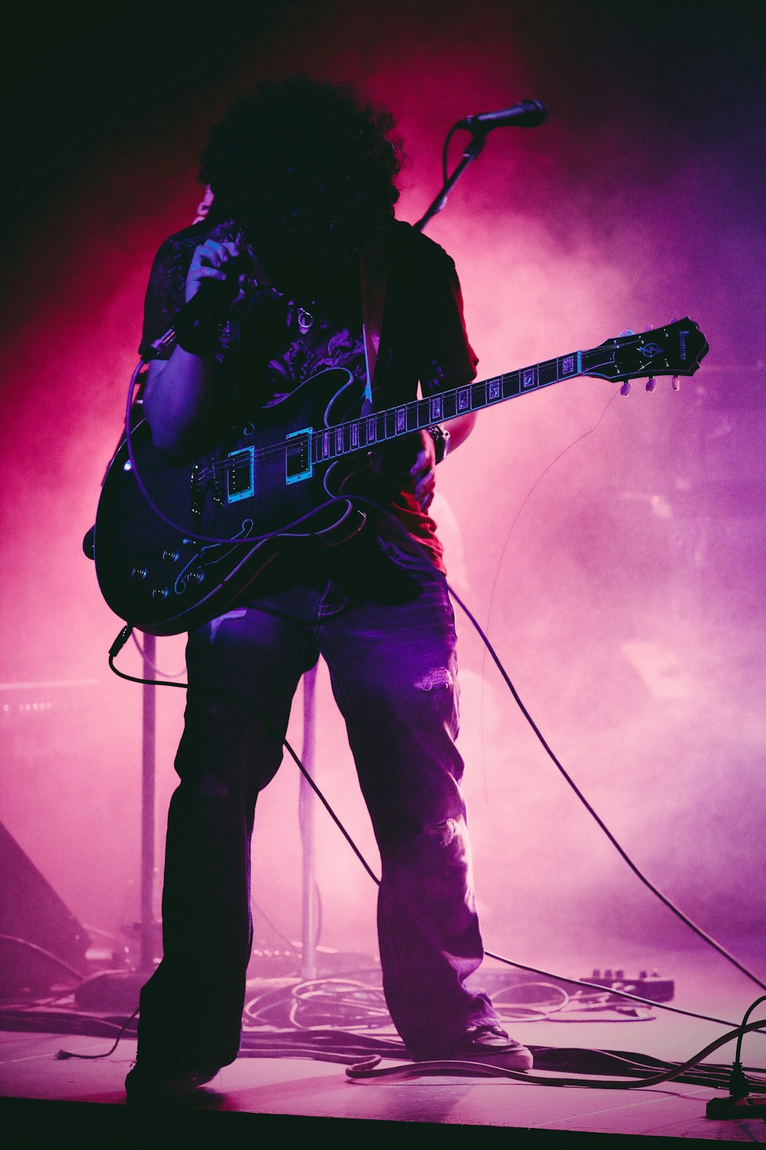 man with guitar on concert stage