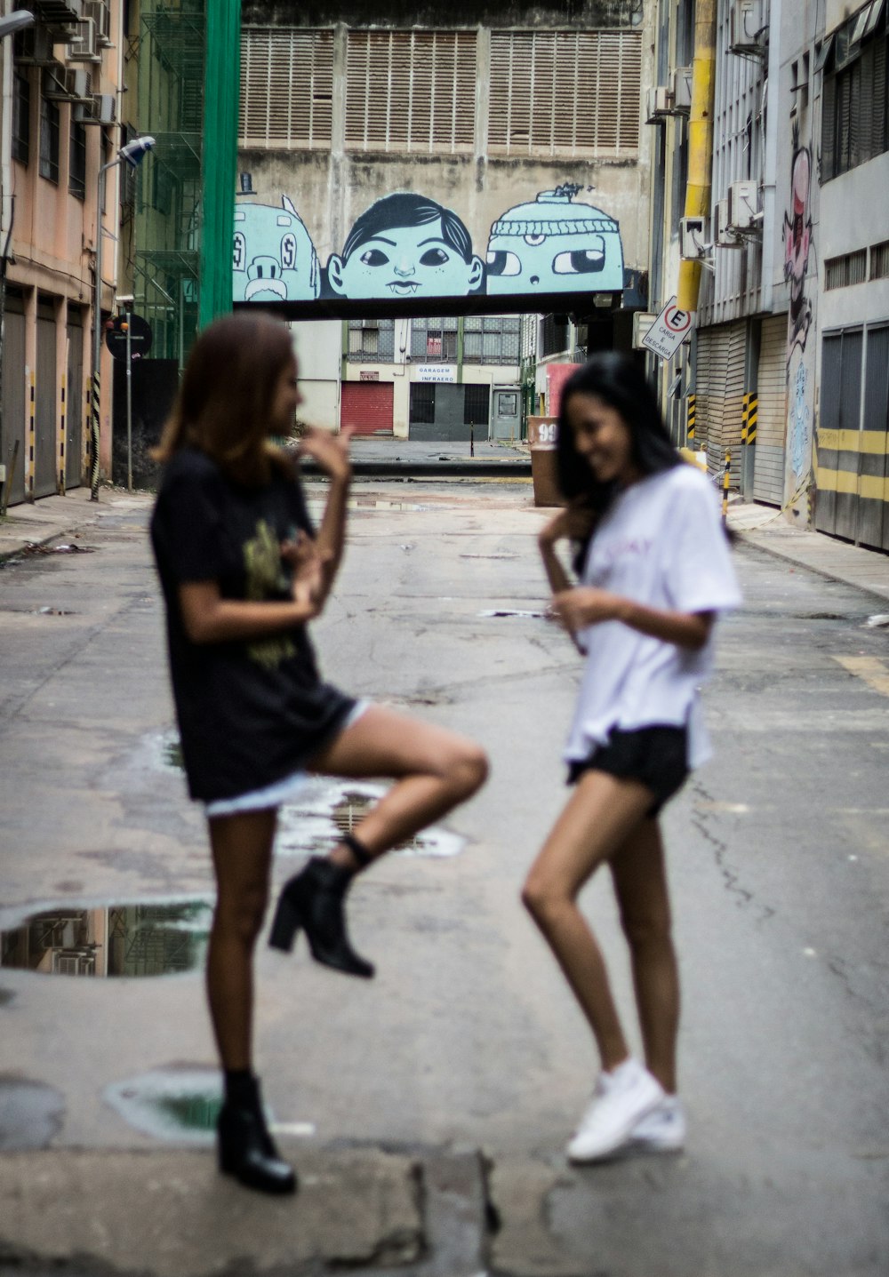 two women in the alley during daytime