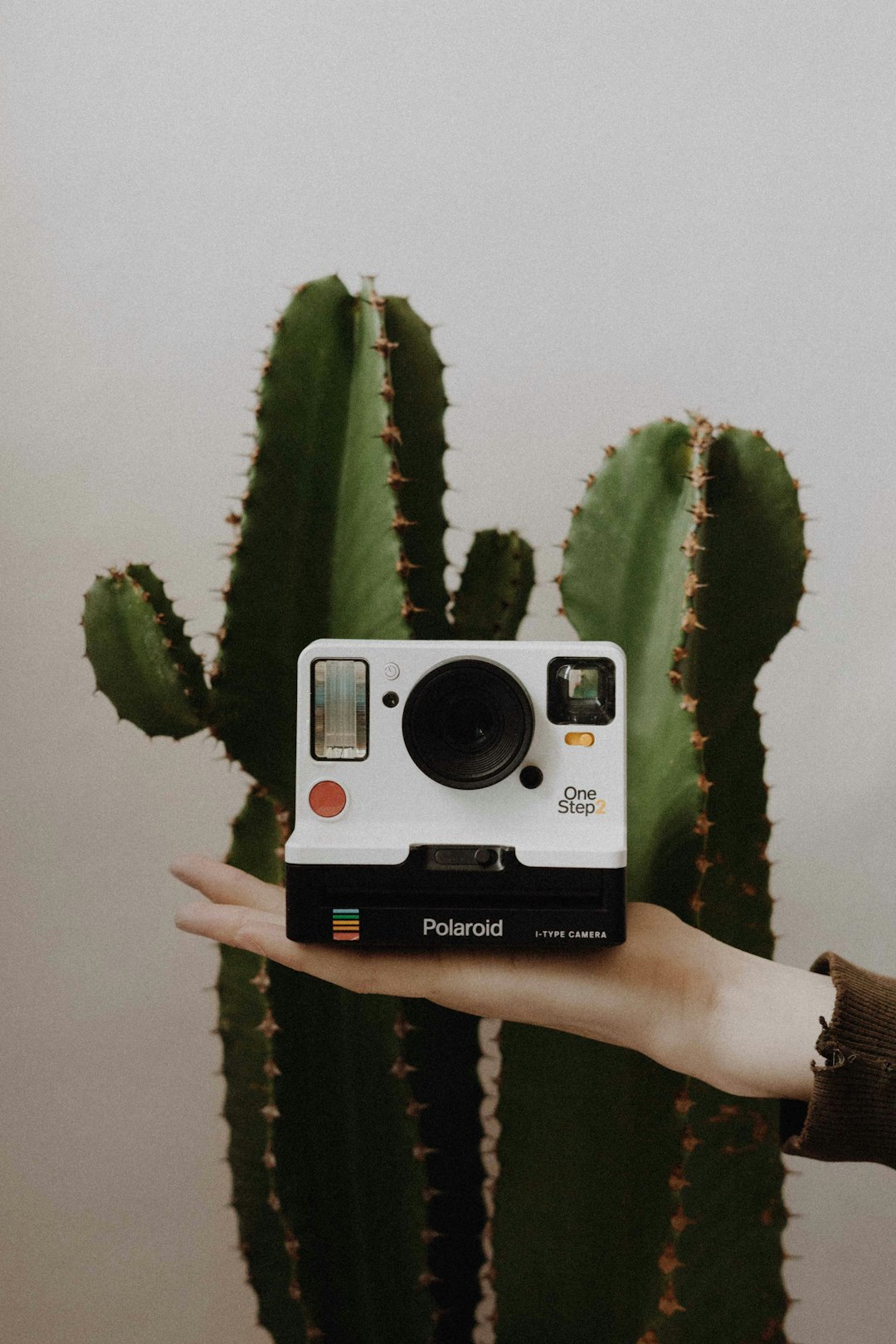 white and black Polaroid One Step instant camera