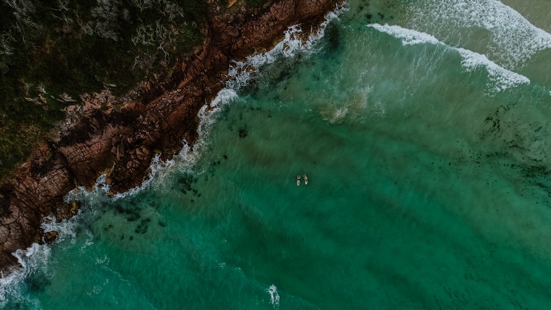 aerial view photography of green ocena water near seashore during daytime