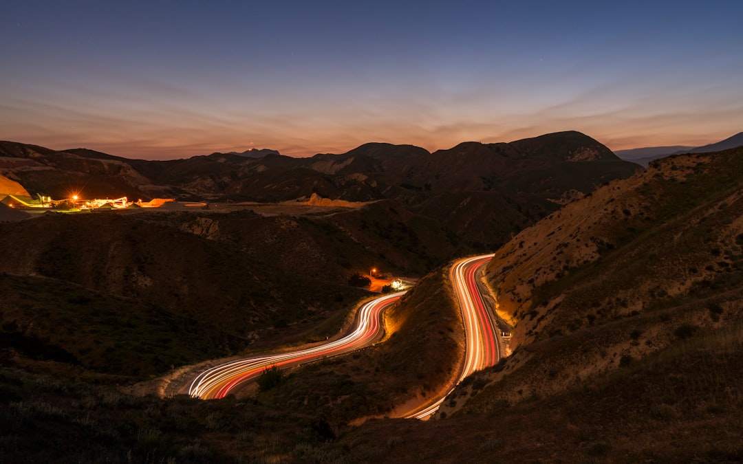 road beside mountain during golden hour