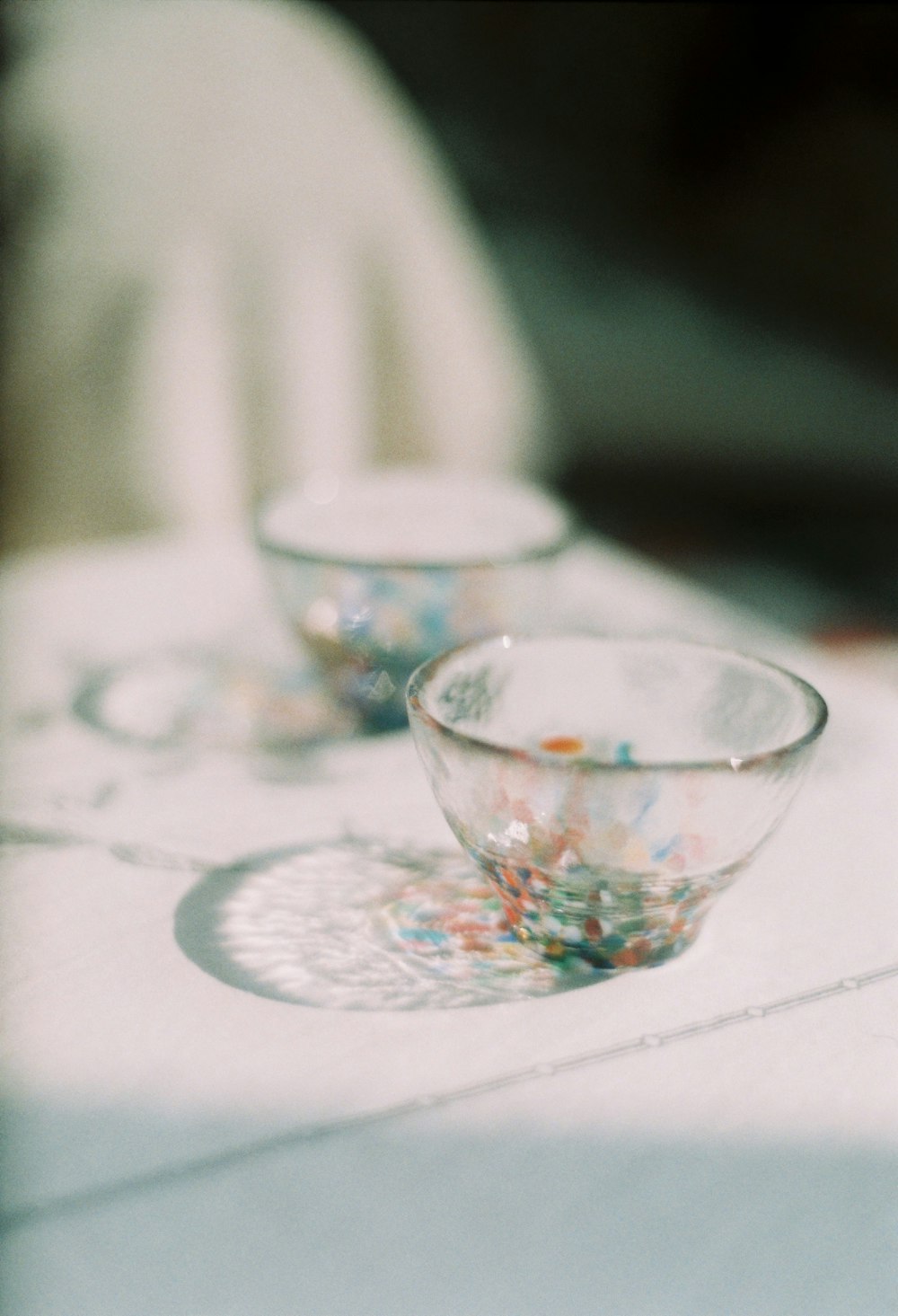 two empty glass bowls on white surfac e