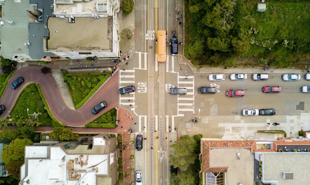 aerial photography of people and vehicles on cross road