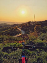 Sunset over a peaceful mountain bike trail winding through the Marche hills.