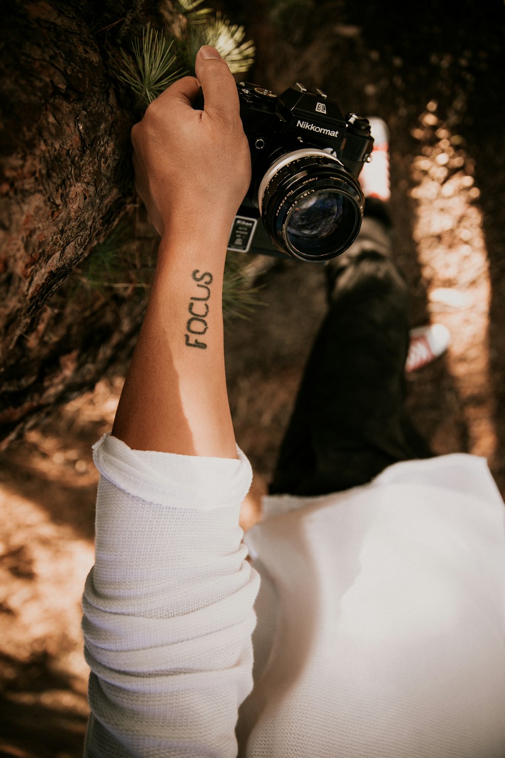 person holding black Nilkormat SLR camera