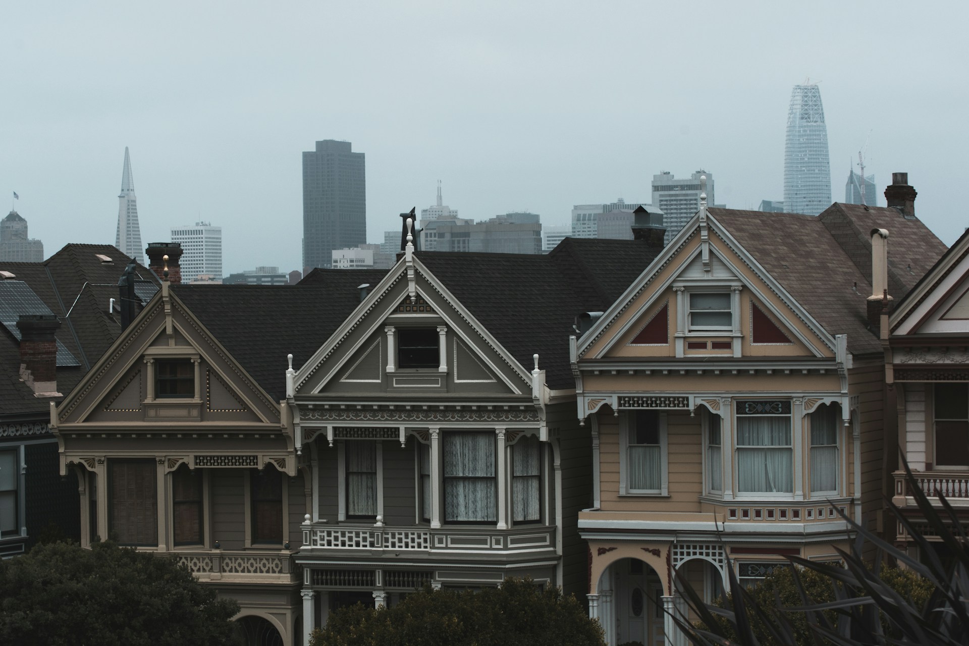 three gray and beige concrete houses under cloudy sky at daytime