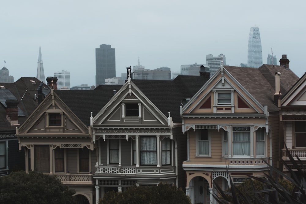 three gray and beige concrete houses under cloudy sky at daytime